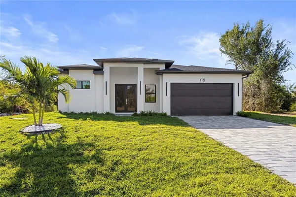 a front view of a house with a yard and garage