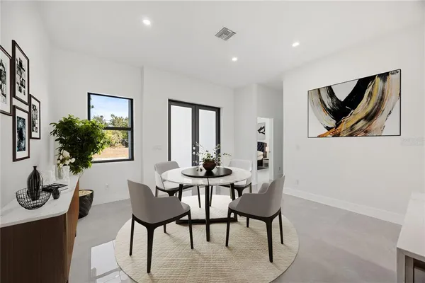a dining room with furniture and window