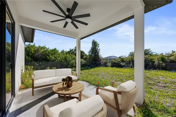 a view of a porch with furniture and a yard