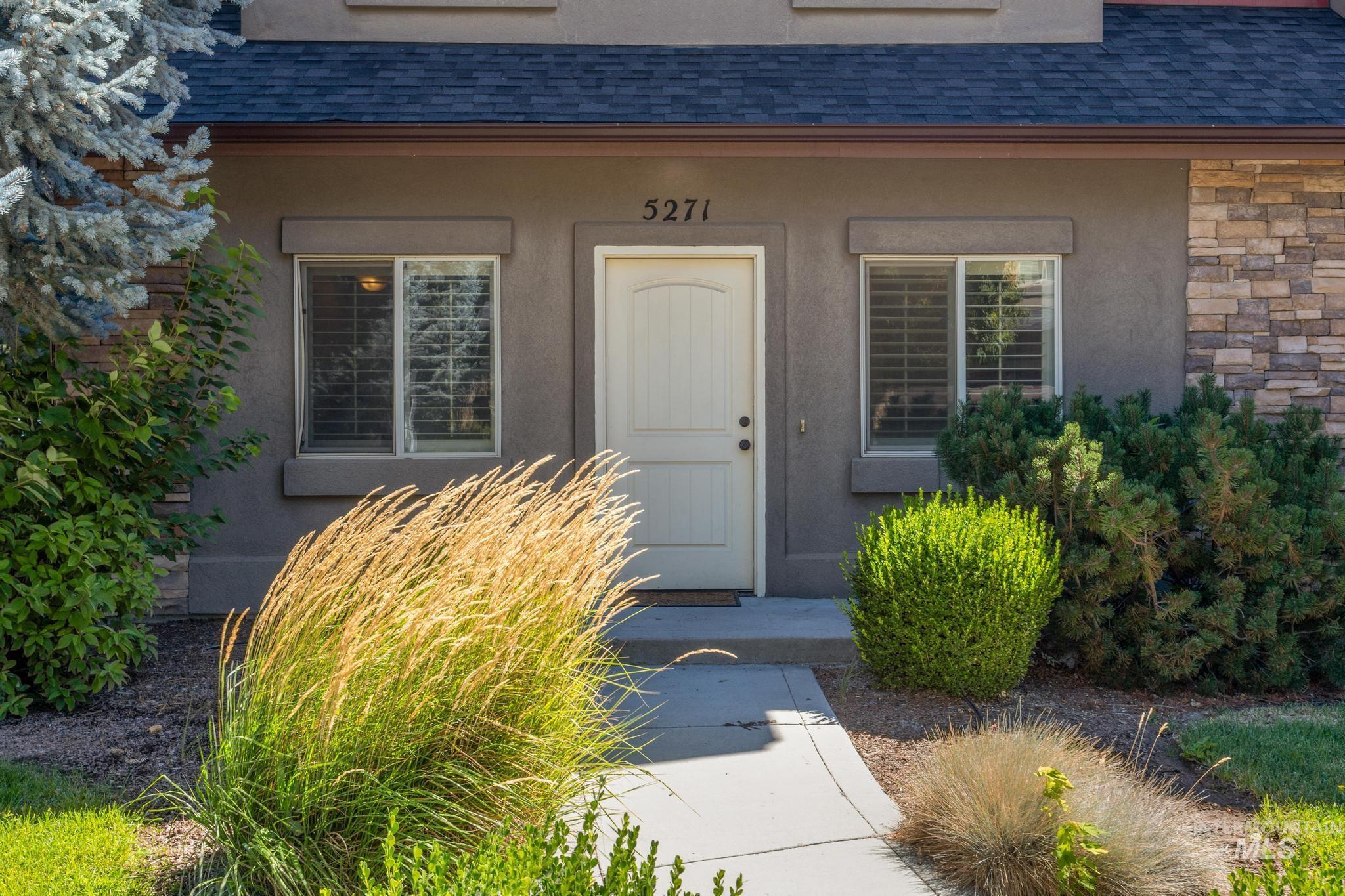 5271 West Morris Hill Road Boise, ID 83706 - Photo 3 of 32 View of exterior entry featuring a shingled roof, stucco siding, and stone siding