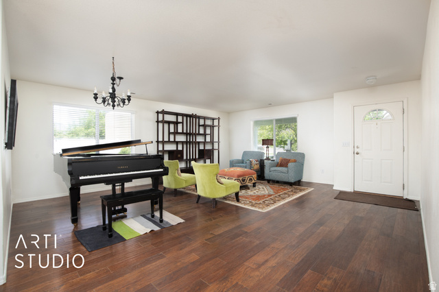 342 South Willow Patch Road Lehi, UT 84043 - Photo 10 of 30 Expansive interior featuring wood-finish flooring, a white paneled entry door with an arched glass insert, large windows, and a built-in shelving unit