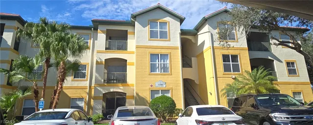 a front view of a residential apartment building with a yard
