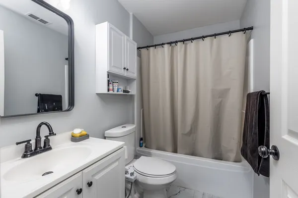 a bathroom with a sink a toilet and a mirror