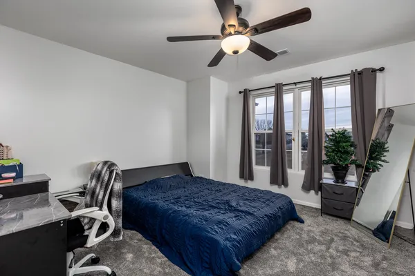 a bedroom with a bed and a chair