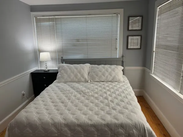 a large white bed in a small room