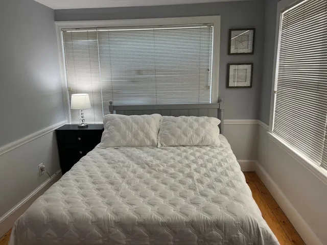 a large white bed in a small room