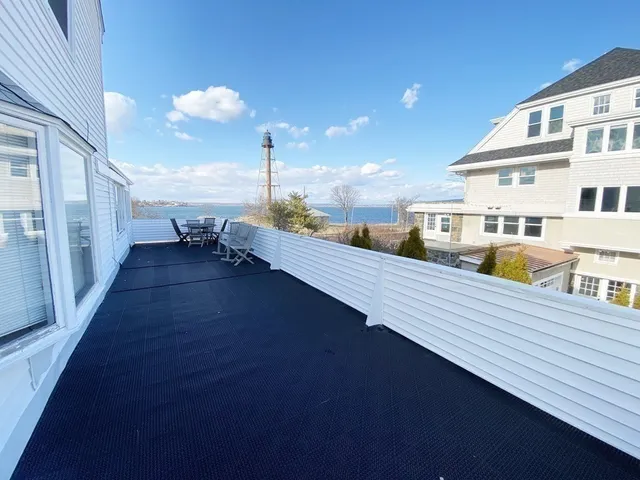 a view of a balcony with dining table