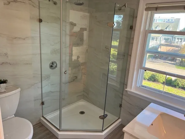 a bathroom with a shower and a toilet