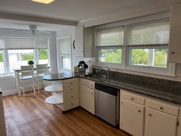 a kitchen with sink cabinets and wooden floor