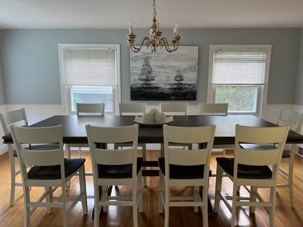 a view of a dining room with furniture and wooden floor
