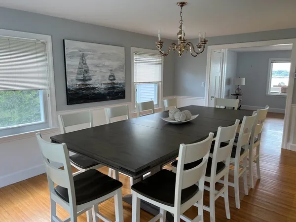 a view of a dining room with furniture wooden floor and chandelier