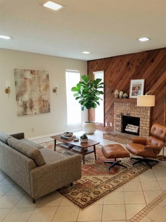 405 Gatewood Road Garland, TX 75043 - Photo 2 of 5 This photo of the living room has been virtually staged with furnishings. It features Tile floors, recessed ceiling lighting, brick fireplace, wood accent wall, and new white faux wood Blinds.