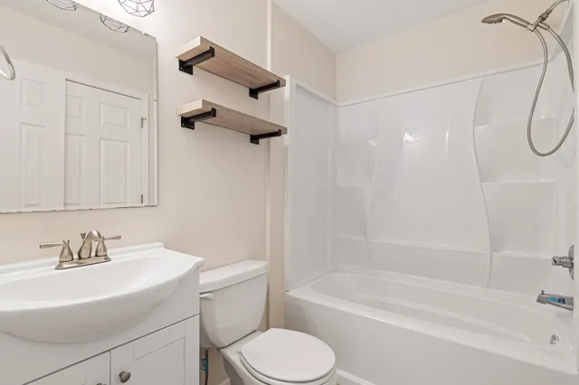 a bathroom with a sink a toilet and a bathtub