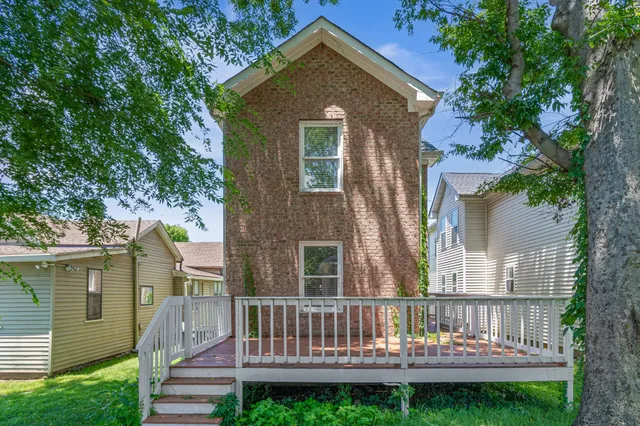 a view of a house with a yard and a deck