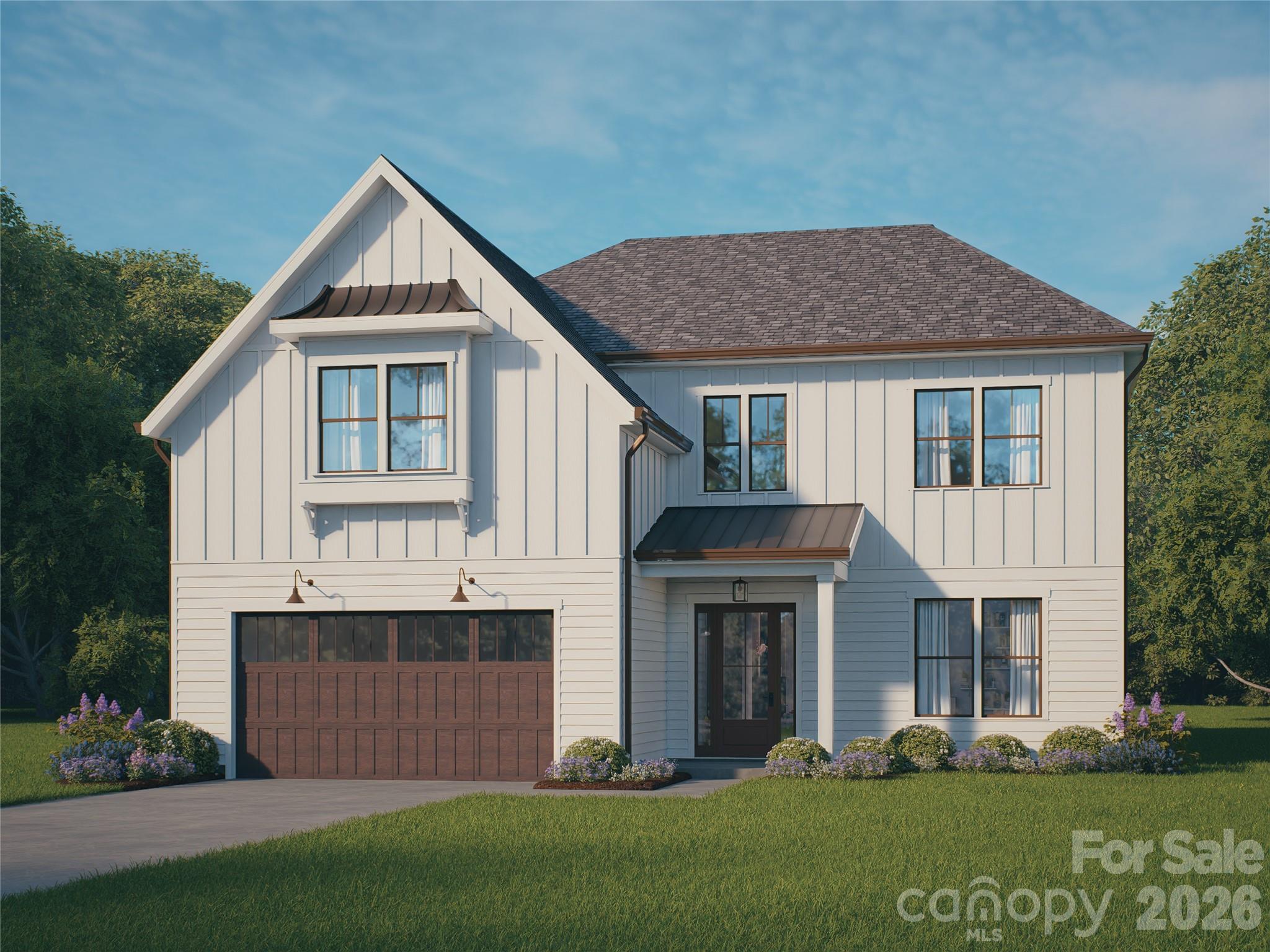 a front view of a house with a yard and trees