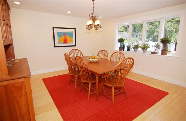 117 Rindge Avenue Cambridge, MA 02140 - Photo 3 of 24 a dining room with furniture a rug a potted plant and a chandelier