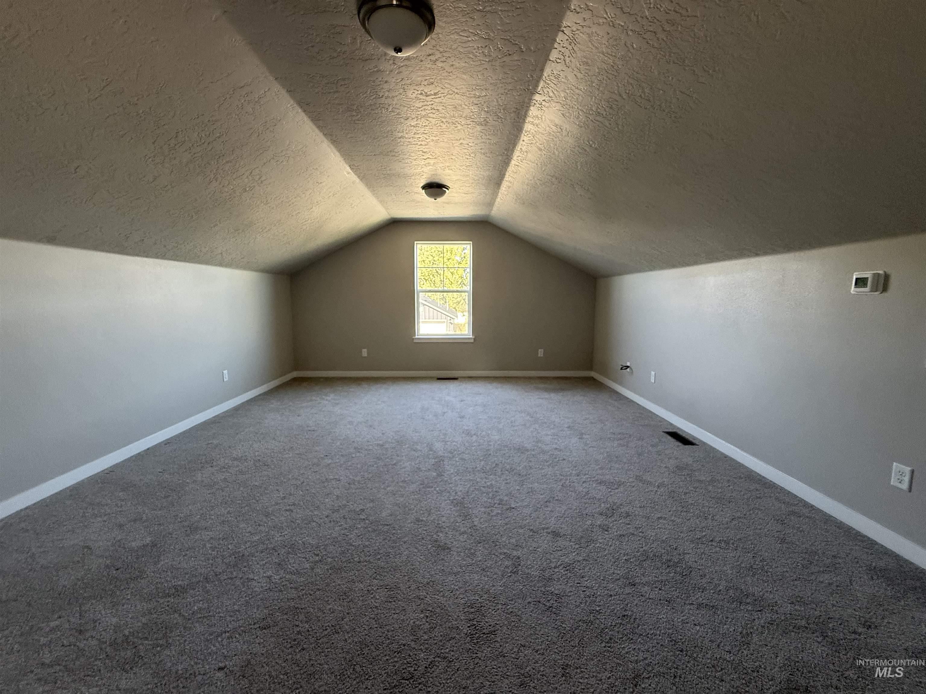 12451 Varga Street Caldwell, ID 83607 - Photo 23 of 30 Carpeted floor, sloped ceilings, recessed window, flush-mount lighting, neutral wall tones
