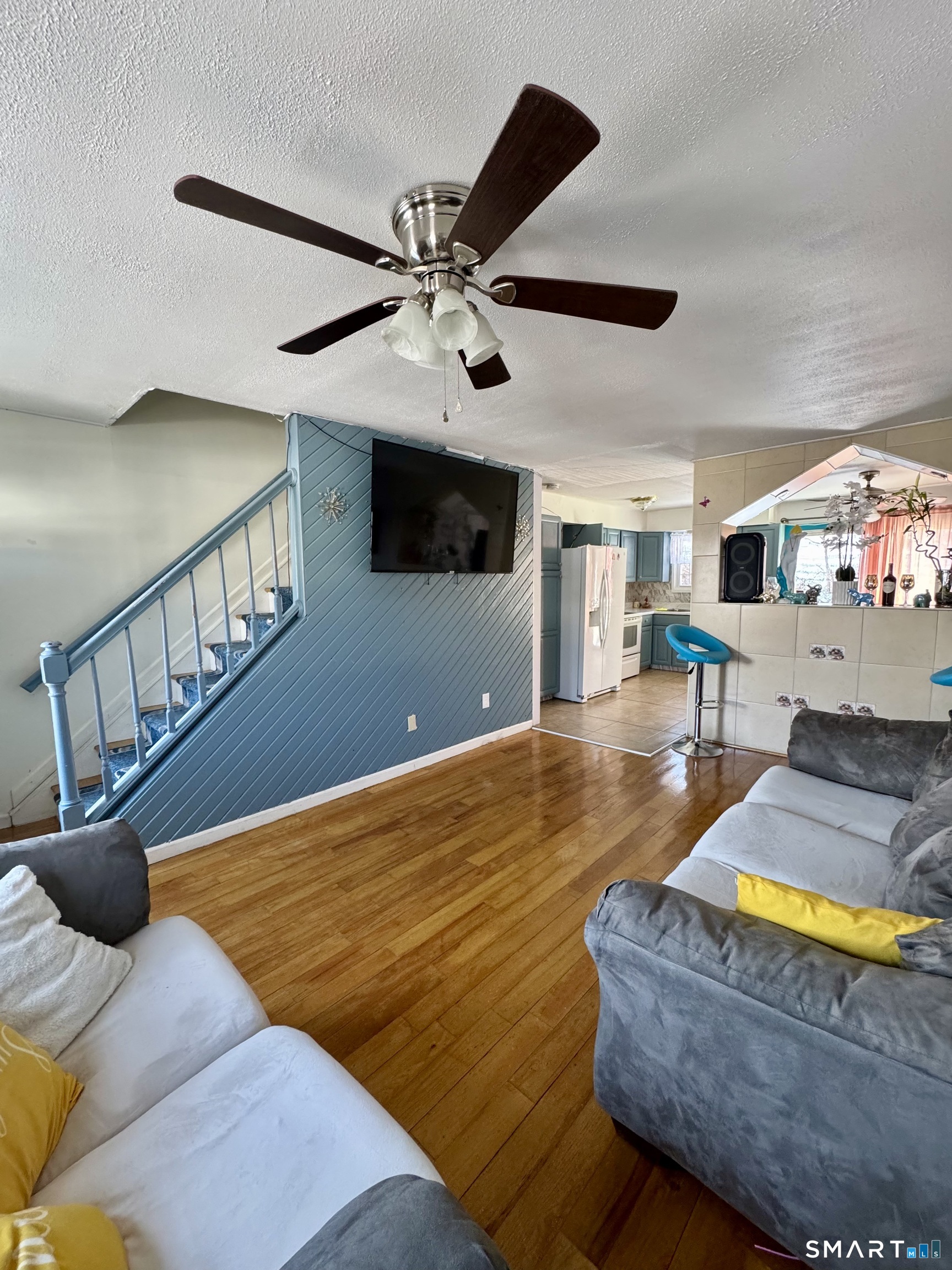 12-16 Scuppo Road, Unit D4 Danbury, CT 06811 - Photo 5 of 8 a living room with furniture flat screen tv and a chandelier