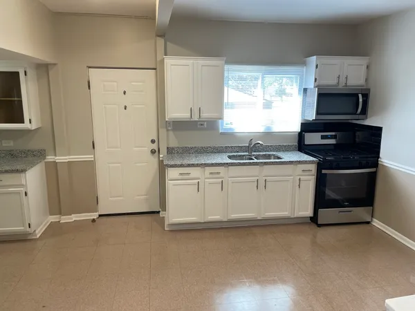 a kitchen with stainless steel appliances a stove sink and refrigerator