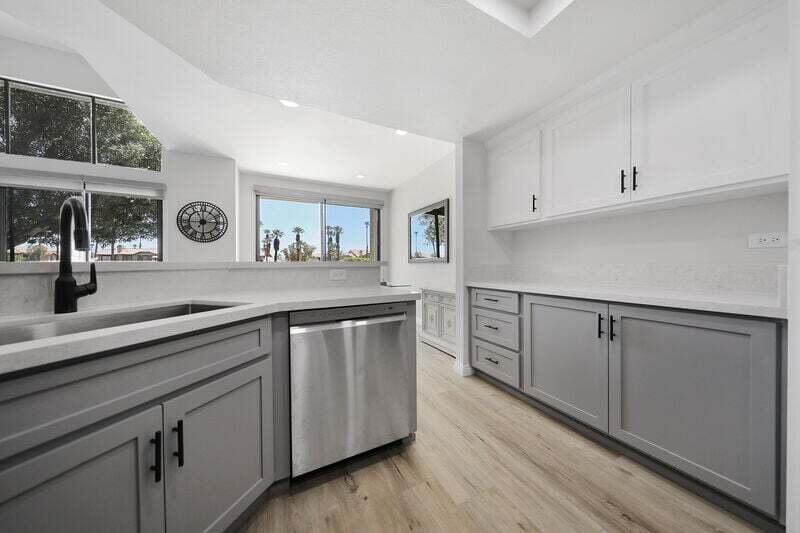 55288 Firestone La Quinta, CA 92253 - Photo 11 of 20 a kitchen with white cabinets and sink