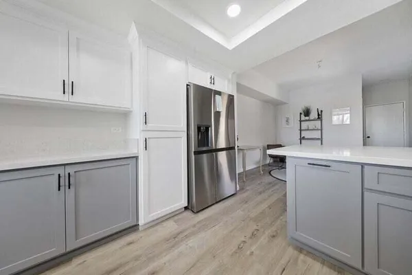 a kitchen with white cabinets and stainless steel appliances