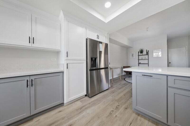 55288 Firestone La Quinta, CA 92253 - Photo 3 of 20 a kitchen with white cabinets and stainless steel appliances