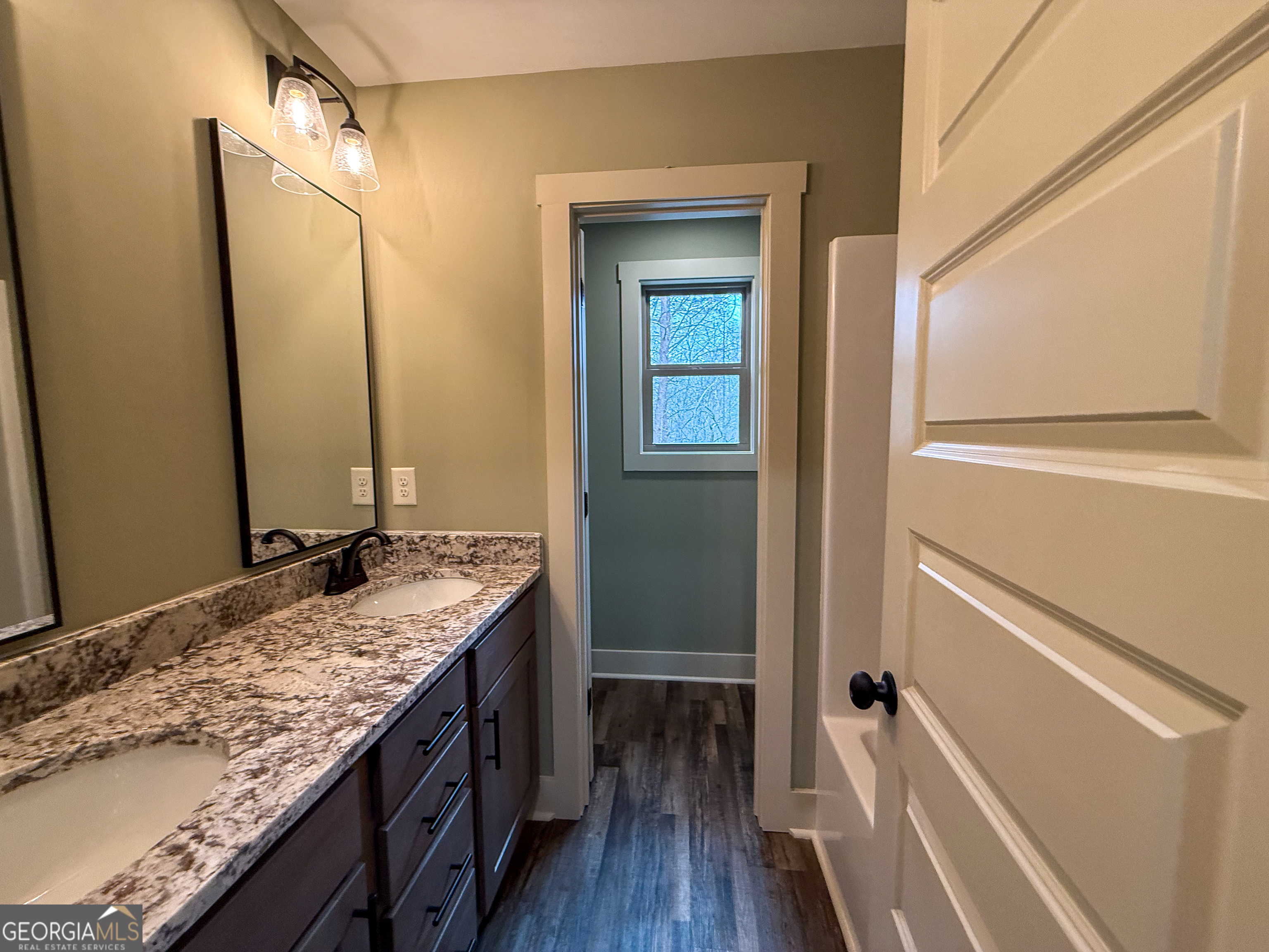 18 Creek Bend Point Cleveland, GA 30528 - Photo 18 of 37 a bathroom with a granite countertop sink and a mirror