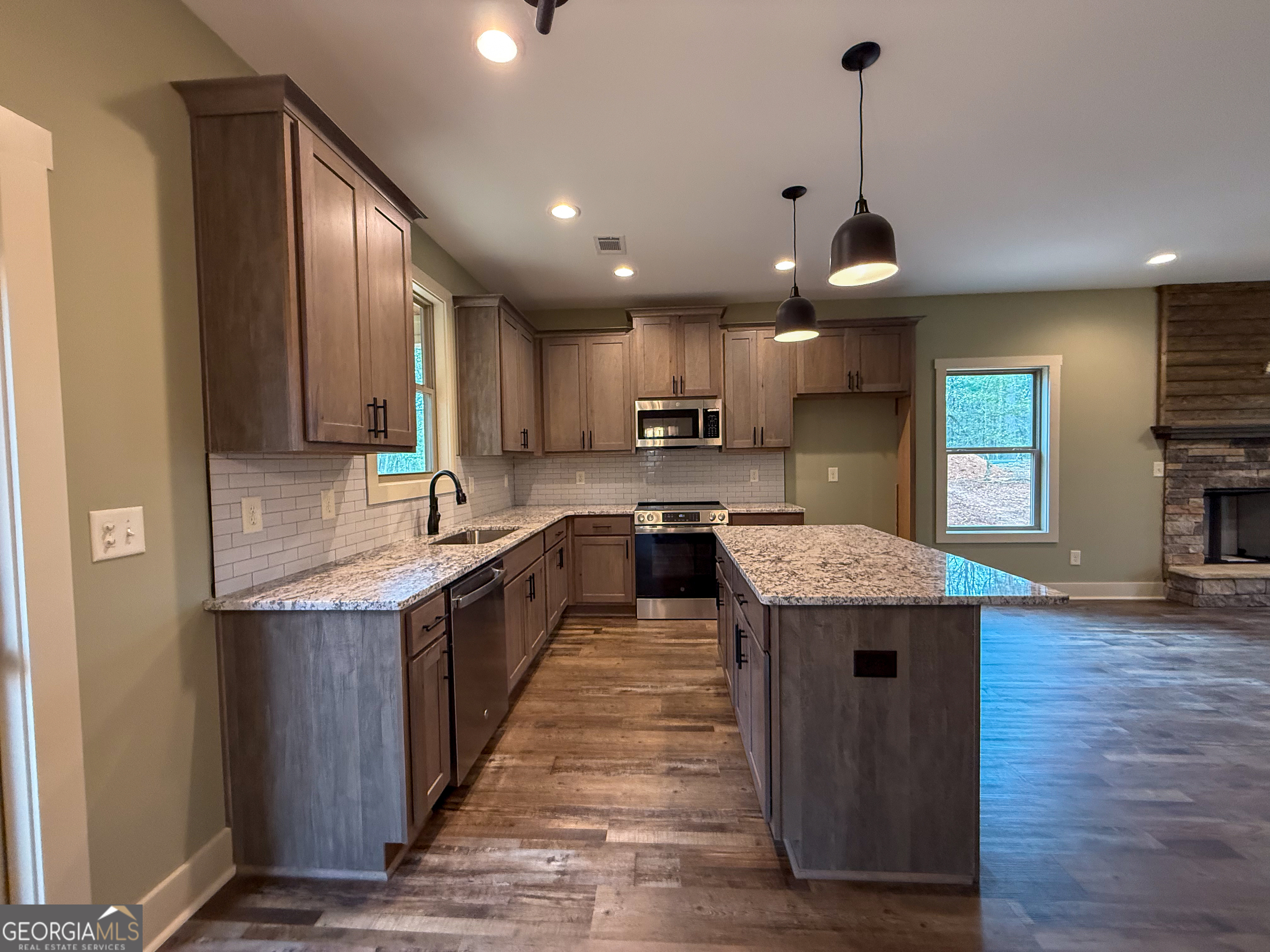 18 Creek Bend Point Cleveland, GA 30528 - Photo 2 of 37 a large kitchen with stainless steel appliances granite countertop a sink a stove and a wooden floors
