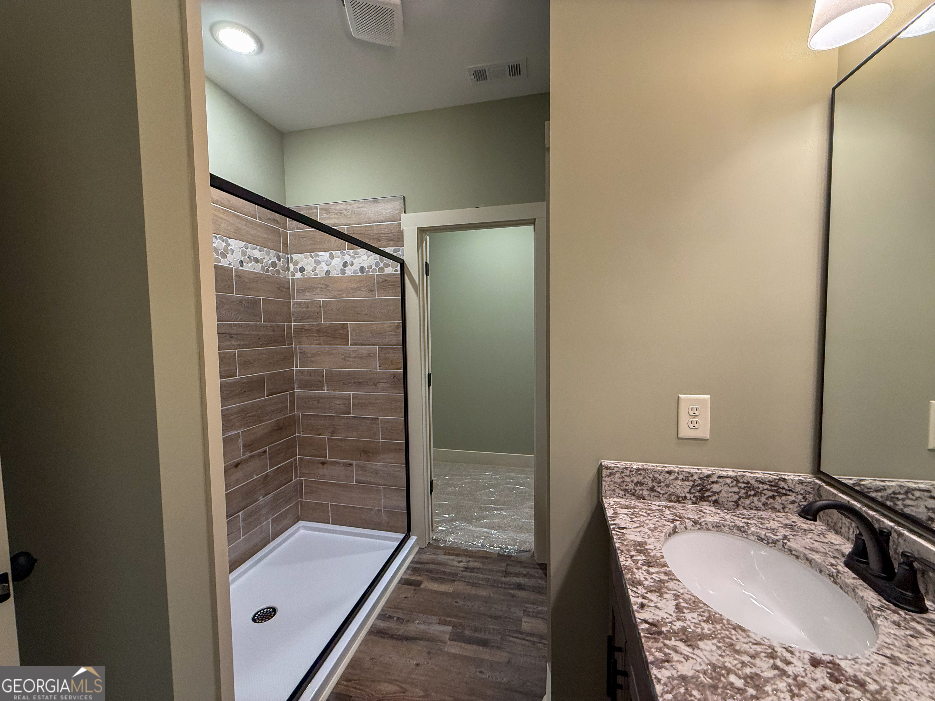 18 Creek Bend Point Cleveland, GA 30528 - Photo 26 of 37 a bathroom with a granite countertop sink a mirror and shower