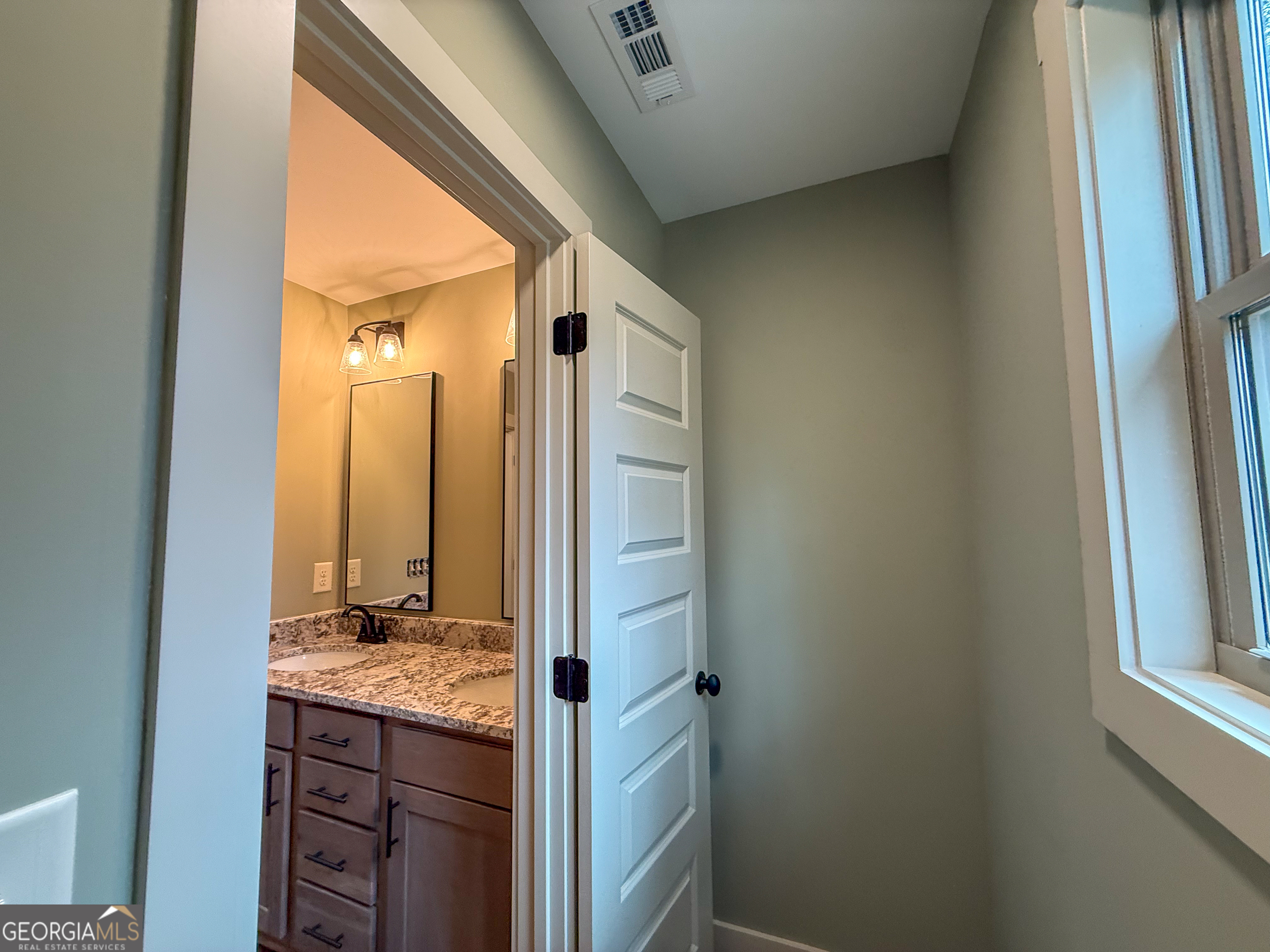 18 Creek Bend Point Cleveland, GA 30528 - Photo 29 of 37 a bathroom with a granite countertop sink and a mirror