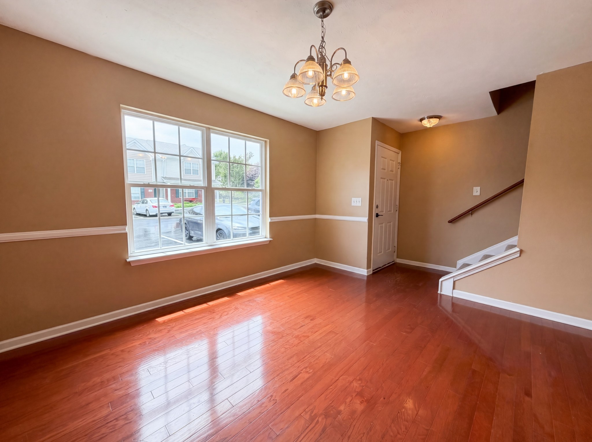 2032 Shaylin Loop Antioch, TN 37013 - Photo 3 of 15 a view of an empty room with wooden floor and a window