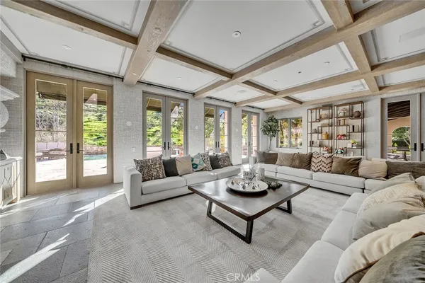 a living room with furniture potted plant and a large window