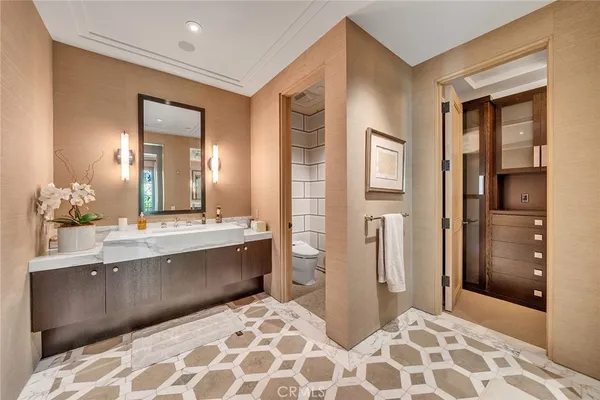 a spacious bathroom with a sink and a mirror