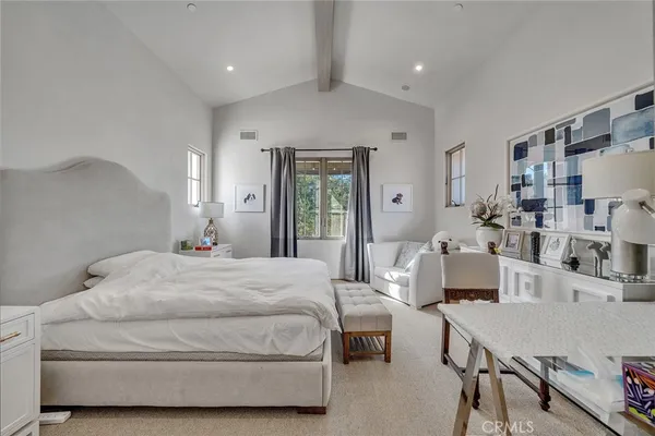 a bedroom with a bed a table and chair