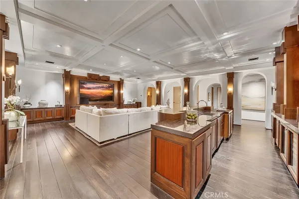 a kitchen with stainless steel appliances granite countertop a refrigerator a stove top oven a sink with island and chairs