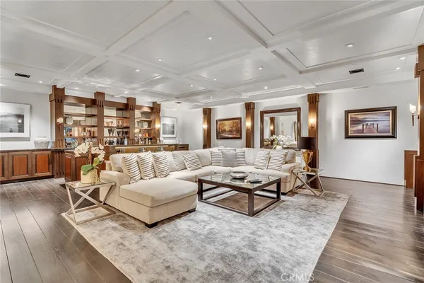 a living room with lots of furniture and wooden floor