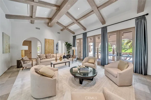 a living room with furniture and floor to ceiling windows