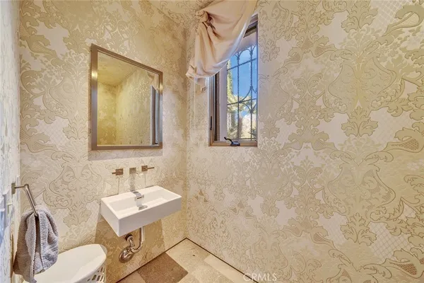 a bathroom with a sink a toilet and mirror
