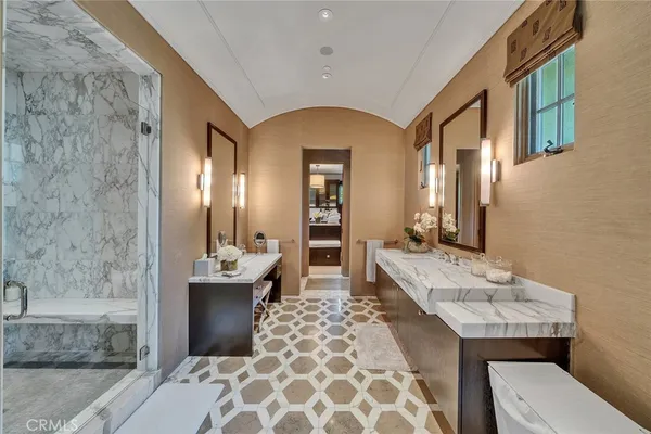 a bathroom with a double vanity sink mirror and bathtub