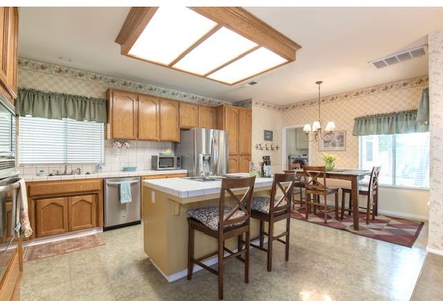 1230 Minarets Avenue Clovis, CA 93611 - Photo 11 of 19 a kitchen with lots of counter top space and dining table