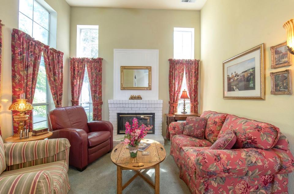 1230 Minarets Avenue Clovis, CA 93611 - Photo 12 of 19 a living room with furniture fireplace and a large window