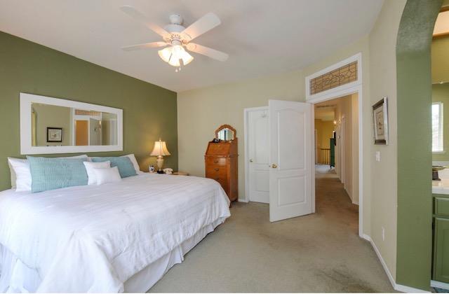 1230 Minarets Avenue Clovis, CA 93611 - Photo 14 of 19 a bedroom with a bed and a chandelier