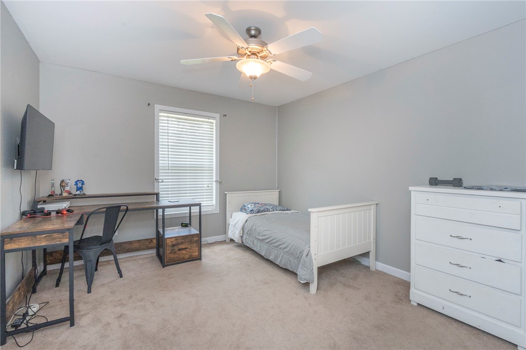861 North Old Pendleton Road Liberty, SC 29657 - Photo 27 of 45 A comfortable bedroom, illuminated by natural light, includes soft carpet flooring and a ceiling fan for climate control.