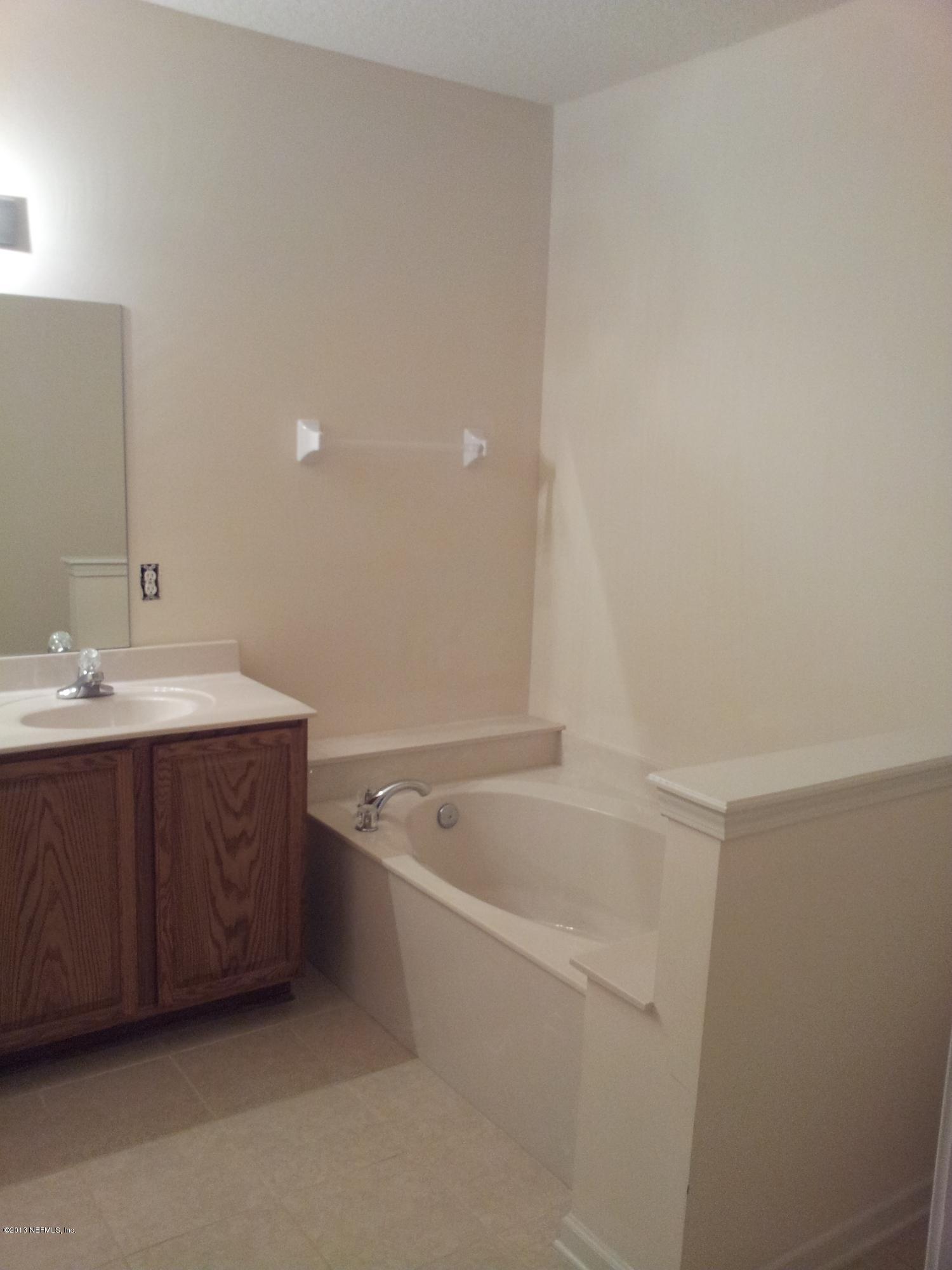 3162 Ravines Road Middleburg, FL 32068 - Photo 11 of 16 a bathroom with a tub sink and mirror