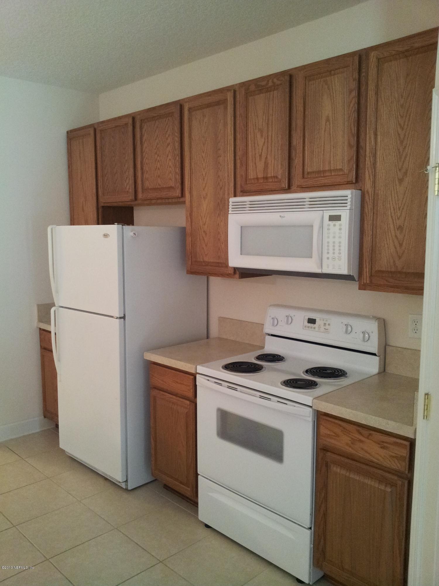 3162 Ravines Road Middleburg, FL 32068 - Photo 3 of 16 a kitchen with a stove and a refrigerator