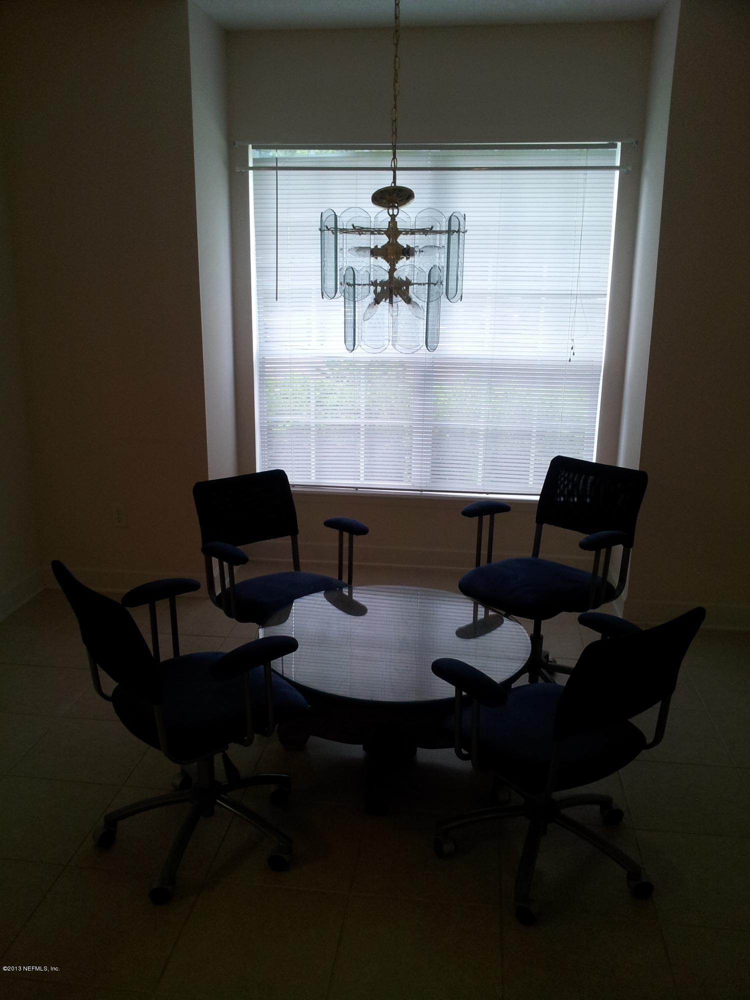 3162 Ravines Road Middleburg, FL 32068 - Photo 7 of 16 a dining room with furniture and wooden floor