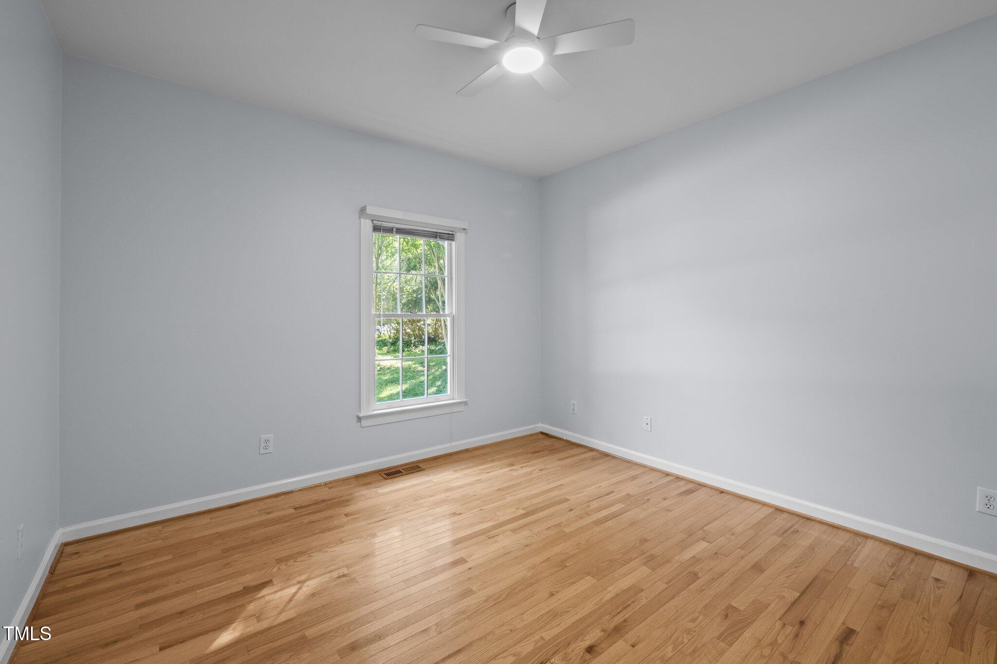 2123 Fountain Ridge Road Chapel Hill, NC 27707 - Photo 23 of 46 an empty room with wooden floor and windows