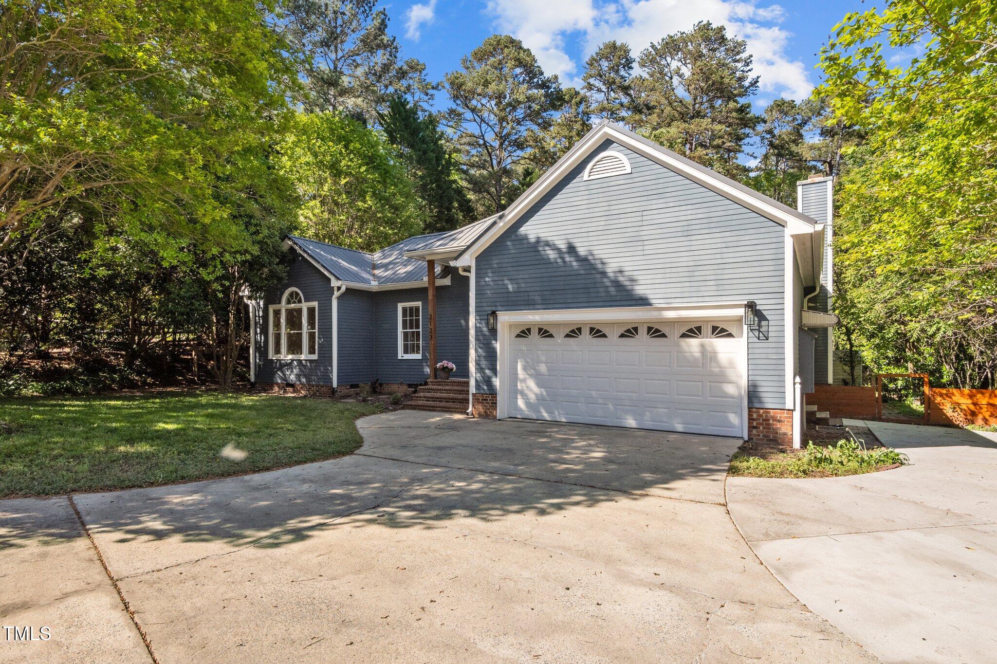 2123 Fountain Ridge Road Chapel Hill, NC 27707 - Photo 41 of 46 a front view of a house with a yard and garage