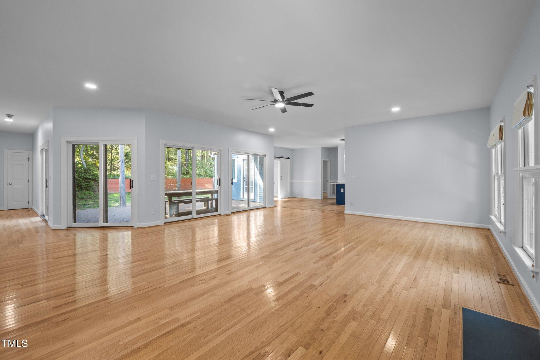 2123 Fountain Ridge Road Chapel Hill, NC 27707 - Photo 6 of 46 a view of an empty room with wooden floor and a window