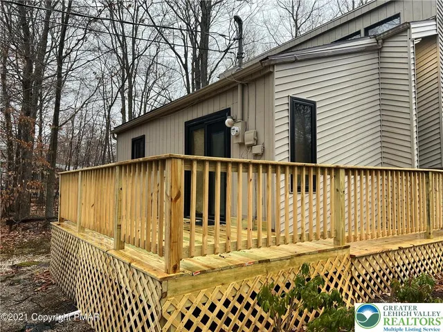 a view of a house with a wooden fence